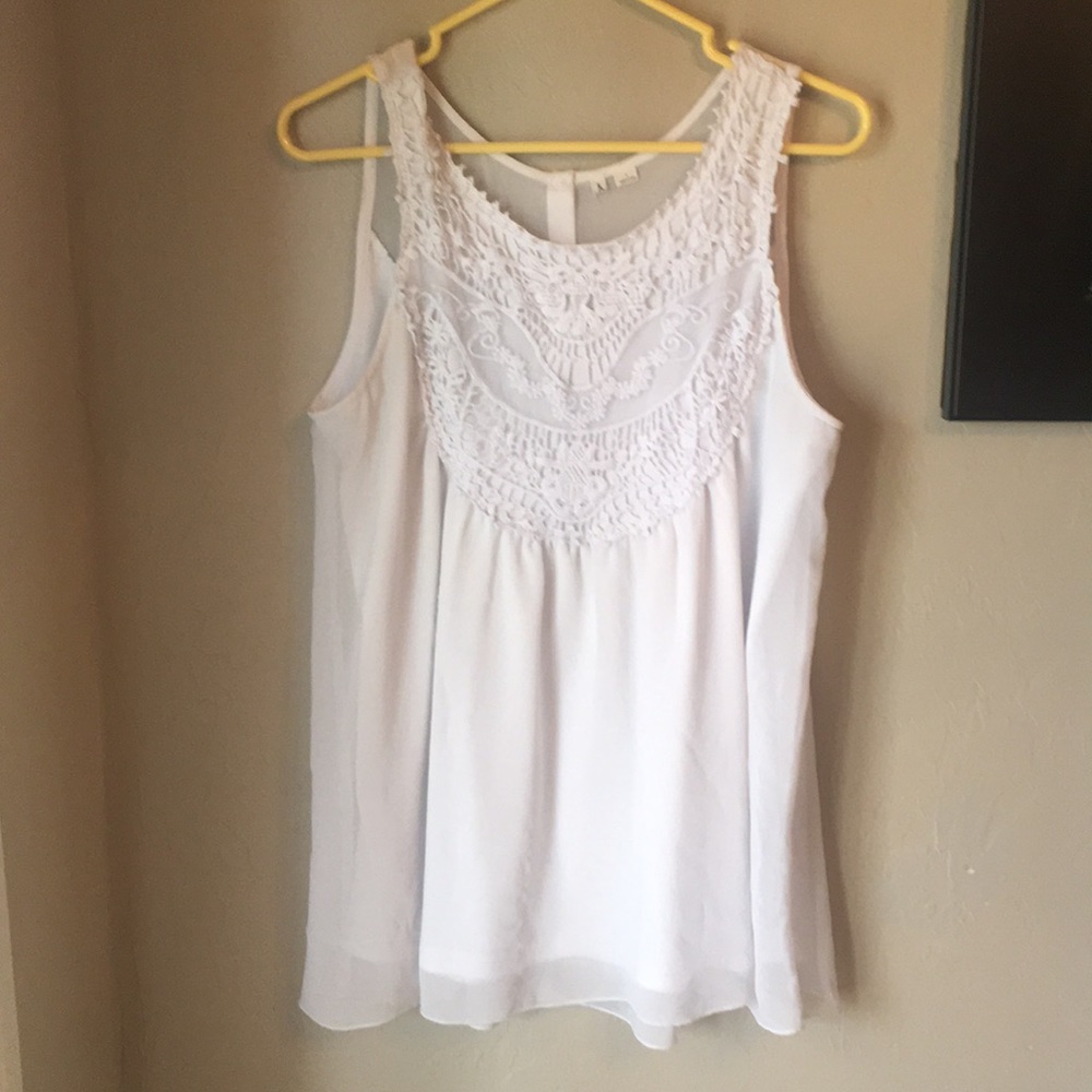 Flowy, white top with detailing.
